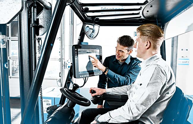 Picture shows forklift operator sitting in forklift with view to terminal